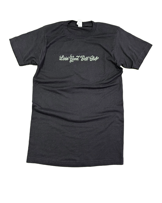A dark charcoal gray short-sleeve t-shirt with 'Love Your Bad Guys' printed in a light green cursive font across the chest, displayed flat against a white background.