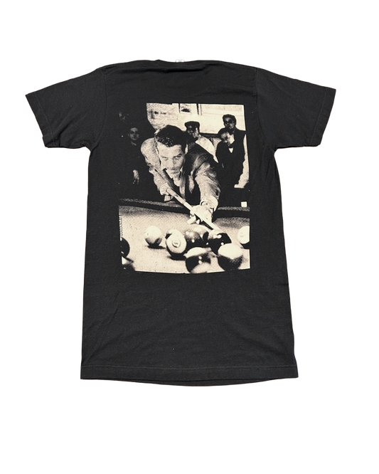 A black short-sleeve t-shirt with a large black-and-white graphic print on the back depicting a man playing pool.