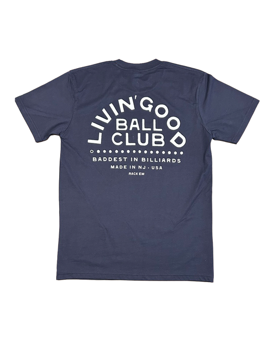 A navy blue short-sleeve t-shirt shown from the back, featuring a large white graphic print that reads 'LIVIN' GOOD BALL CLUB' with 'BADDEST IN BILLIARDS MADE IN NJ, USA' underneath.